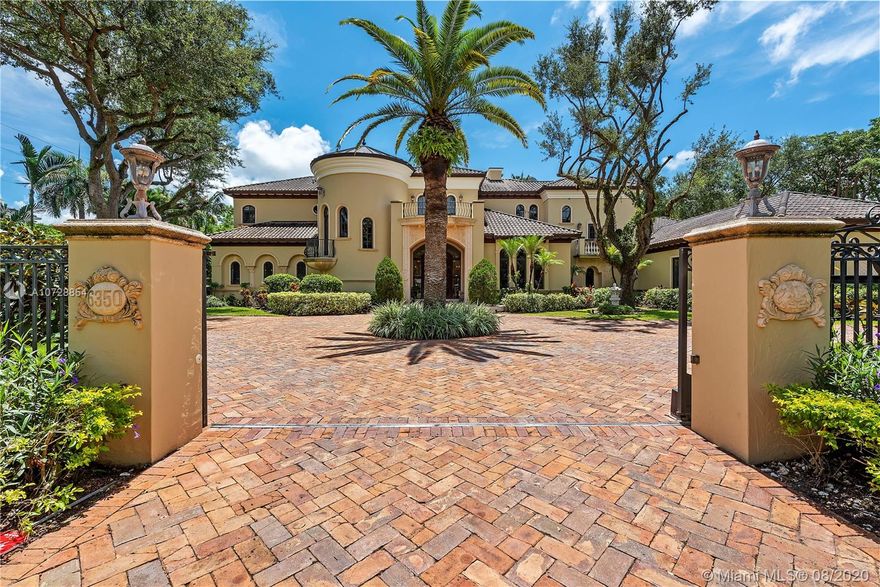Extraordinary, pristine two story Italian villa in North Pinecrest, with legendary Hollub Homes design and construction. Unmatched living and entertaining spaces. Formal living and dining room, executive library with gorgeous built-ins and double-sided fireplace, billiard/game room, bar and wine cellar, stunning European kitchen with brick ceiling. The expansive master suite of over 1700 square feet is palatial, with separate marble baths and walk-in closets and an exercise room with exterior access to the resort-like pool and grounds. Ultimate flexibility with 5 additional en suite bedrooms. Other distinct features include a second floor loft with kitchen and additional laundry, custom exquisite finishes and design details throughout. Impact glass. A MUST SEE!