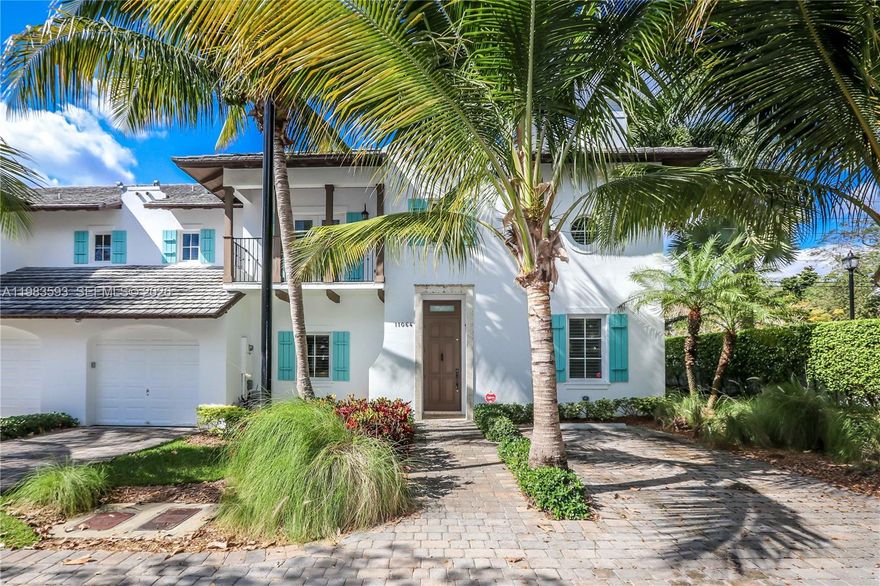 Dutch Caribbean Style Townhome Corner Unit with 4 beds, 3.5 baths with 1 bed/office downstairs.  20' vaulted ceilings, in exclusive gated community across from Pinecrest, within the heralded Pinecrest school system. Largest floor plan in the most desirable spot in the complex. Saturnia Marble floors throughout with Brazilian Cherry wood in upstairs bedrooms. Fireplace, custom kitchen cabinets with granite tops, GE Profile appliances, hurricane impact windows, 1 car garage with storage, private parking for 2 more cars & a clubhouse with a great pool.  Delivered freshly painted and very well maintained with plantation shutters throughout and a private tiled patio. Easy to show.