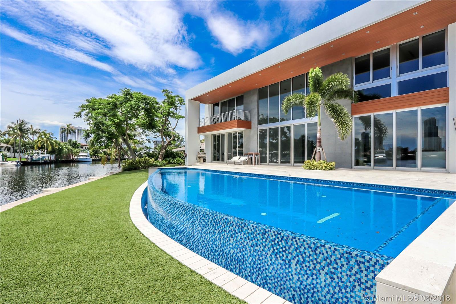 Polished modern, new construction two story residence located in the gated community of Golden Isles. 
This residence sits on a secluded point lot with a beautiful infinity edge pool overlooking the intercostal.
Space for yachts on both sides. Open floor plan, with natural lighting encompasses this spacious property with immaculate views throughout the interior. Floor to ceiling impact windows, marble flooring, and a separate staffs quarter.