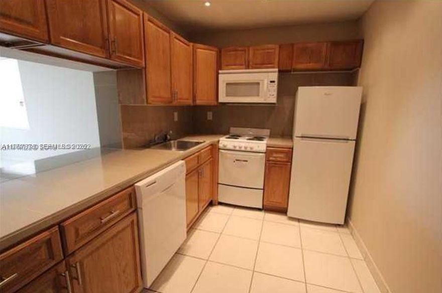 Location, location, location: Prime 2/2 unit near Westland Mall and the Palmetto Expressway, featuring an ample balcony and same-floor laundry.