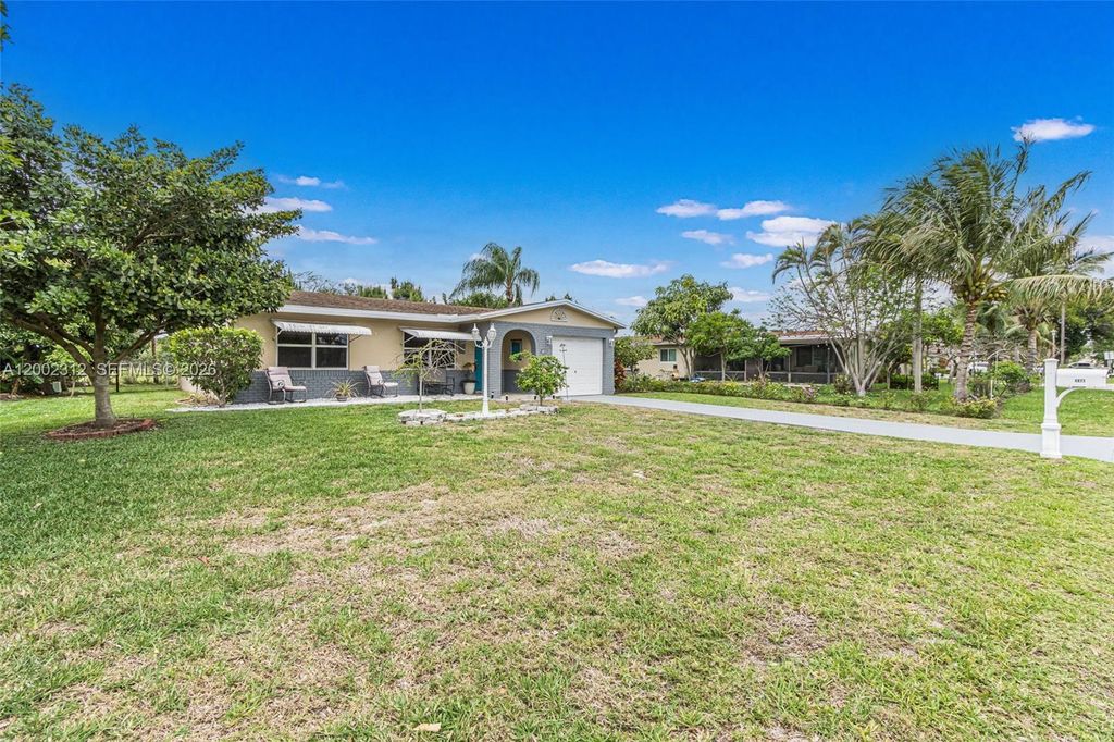 Photo of 4871 NW 13th Ave, Deerfield Beach, FL 33064 (MLS # A12002312)