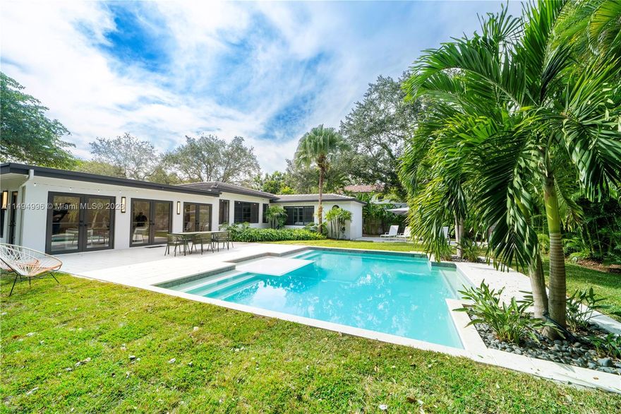 Welcome to this chic & stylish home in the heart of Miami Shores. The property features 3BD/3.5BA, providing ample space for comfortable living. Situated on an oversized 12,900 sq.ft. lot on a coveted street, the home offers a desirable location & multiple features. Recently renovated, the home now expands the living room, blending gardens, outdoor patio & pool. Highlights; 3 large ensuite bedrooms, custom vanities, modern kitchen & finishes, open living areas, high cypress wood ceilings, elegant pool, landscaped gardens, impact windows & doors. The spacious lot offers plenty of room for outdoor entertaining & relaxation, along w/ the opportunity to expand the house. Plenty of parking & convenient alley access. Walk to cafes, shops, restaurants, & enjoy easy access to the city's best!