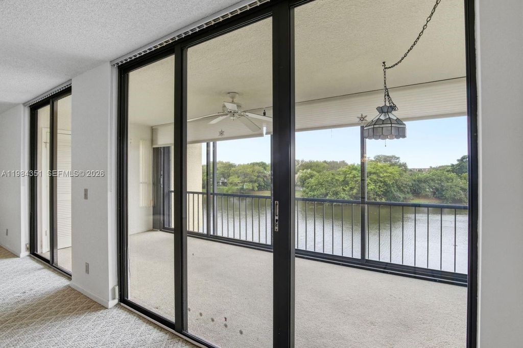 Photo of 5188 Woodland Lakes Dr #337, Palm Beach Gardens, FL 33418 (MLS # A11984351)