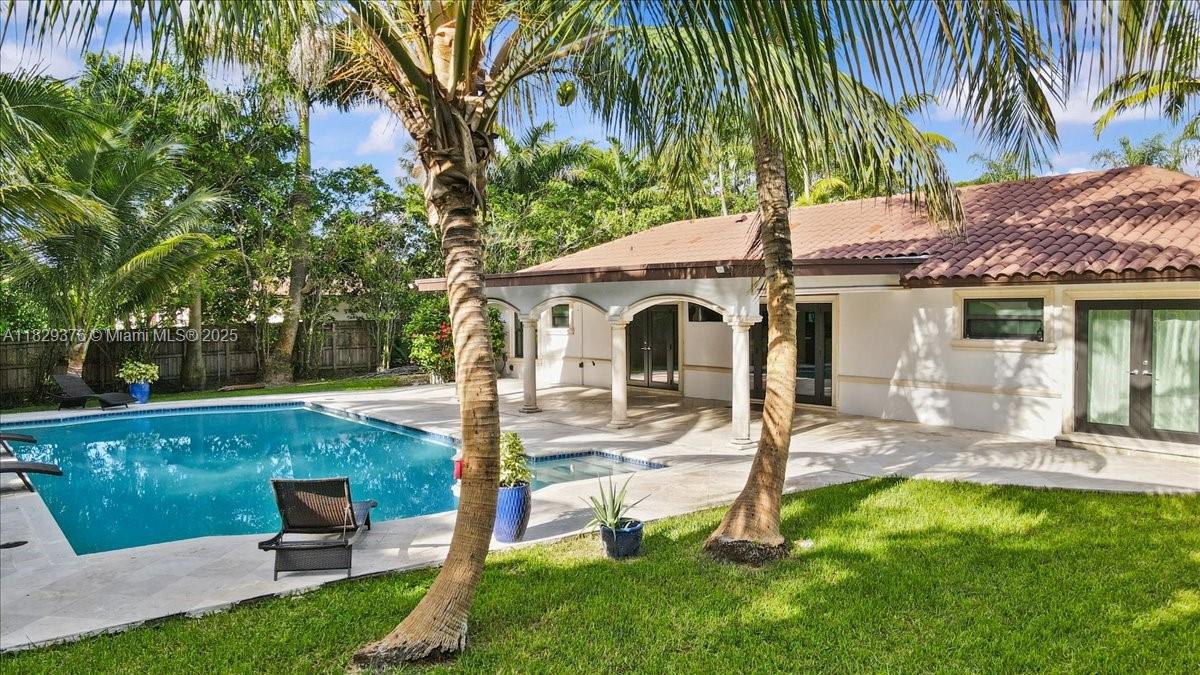 Your private tropical paradise awaits at this stunning Mediterranean gem and one of Palmetto Bay's finest! Dive into one of the neighborhood's largest pools (40'x25') or relax on the spacious covered patio, ideal for relaxing or entertaining. A private, fenced 18k+sq ft backyard is a tropical dream, boasting mature lychee, mango, coconut & ciruela trees. Complete impact windows & doors. Inside, find a meticulously maintained home with new stainless steel appliances, bright open spaces, and elegant travertine tile. Enjoy the cost-saving, well-fed sprinkler system and the convenience of municipal water/sewer. Backyard fence has double doors for RV or boat parking. Nestled in a quiet community with top-rated schools, this is the ultimate South Florida lifestyle! SQF 2016, according to owner.