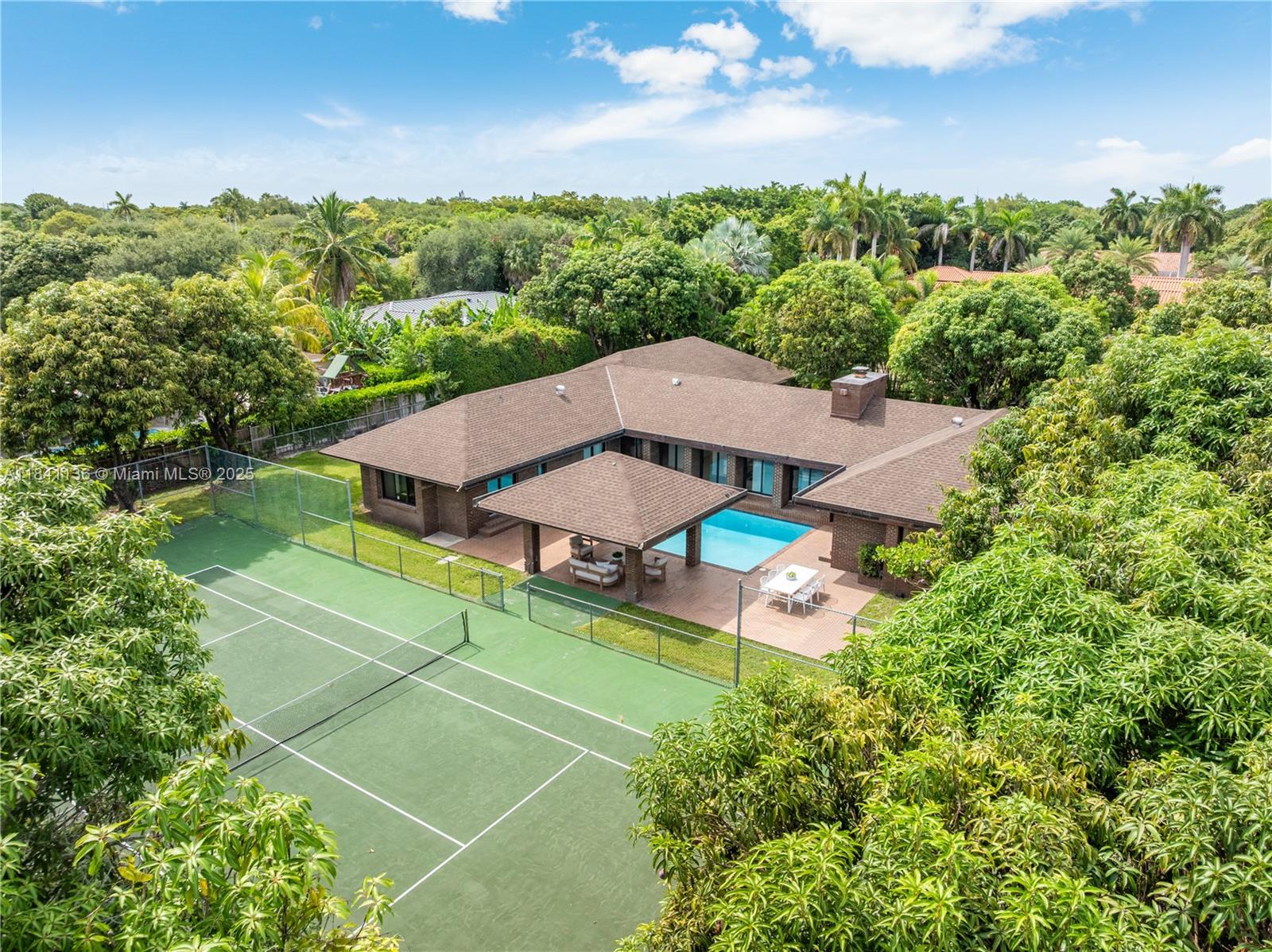 Palmetto Bay Staycation Paradise! Tucked away on a gated acre estate with a mango tree grove and a private tennis court sits this entertainer’s dream home. Along with fantastic open living spaces, this unique 4-bed, 3.5-bath home with 3-car garage has been meticulously renovated with new flooring, a sleek modern kitchen, redesigned bathrooms, upgraded lighting, and impact windows and doors. The gourmet eat-in kitchen opens to a dining room, and a family room with views of the beautiful grounds, pool, and tennis court from all spacious bedrooms. A rare blend of comfort, style, and value in a lush, park-like setting just minutes from top schools, parks, and scenic walking and biking paths. Who is ready to call this slice of paradise, HOME?