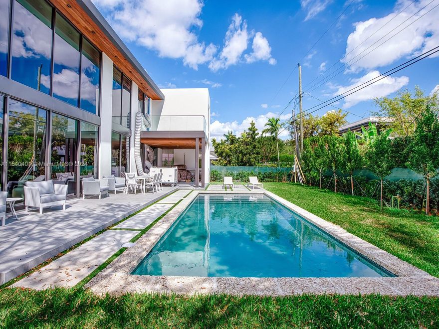 Welcome to this stunning contemporary home located in the High Pines neighborhood. Spanning over 5,260 sqft, it boasts 6 bedrooms and 6.5 bathrooms + a 2-car garage with built-in cabinets. The high ceilings + floor-to-ceiling windows flood the interior with natural light. The 48” X 48” Italian porcelain tile flooring adds elegance. The open kitchen features a top-of-the-line Sub-Zero/Wolf appliance package and ItalKraft custom cabinetry, a bar, and a Subzero wine tower for 160+ bottles. The primary bedroom offers a luxurious and spacious ensuite spa-like bathroom + a spacious master walk-in closet by Italkraft. All bathrooms have ItalKraft Vanities, Toto Toilets + Graff fixtures. Step outside to your private terrace and enjoy the pool and full Summer Kitchen. Sonos Sound system throughout!