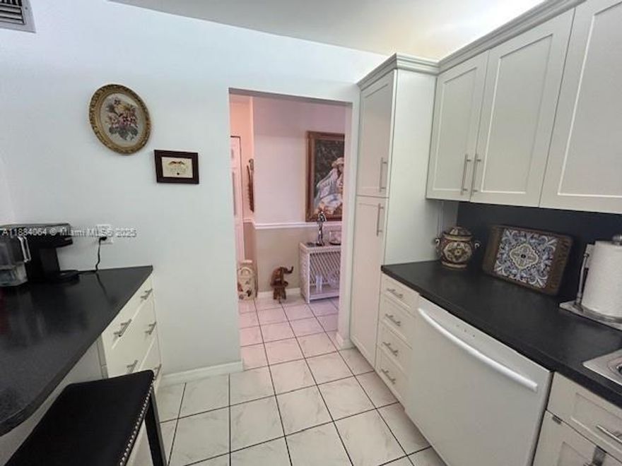 Beautiful updated, impressive view of water and pool. 2 bedroom/2 bathroom condo east of US1, Remodeled eat in kitchen, bathrooms, tile floors, storage unit, built in closets, NEW A/C, HEPA FILTER AIR & WATER PURIFIER throughout, TANKLESS water heater. Primary bedroom with an abundance of closets. New roof, new elevator, new paved parking lot, beautifully maintained community. Furniture & items included in sale. Close to Fort Lauderdale Airport, Cruise Port, walking distance to Publix, Walmart, State Parks and more. Hurricane impact sliding doors & windows, screened balcony, lake view, south exposure, heated pool, BBQ, clubhouse with activities. Assigned parking, Guest parking. NO assessments, full reserves. ALL FURNITURE AND ITEMS IN UNIT ARE INCLUDED MOVE IN READY
