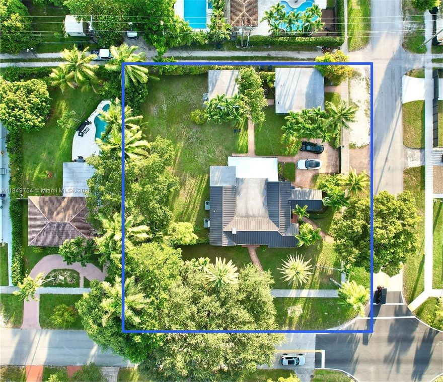 This ultra-rare, multi-family property at 500 South Dr offers 3,898 square feet on a 19,312-square-foot lot. The main house features 4 bedrooms, 3 bathrooms, including a master and en-suite, hardwood floors, high ceilings with wood beam work, and a granite-accented fireplace. The kitchen has real wood cabinets and pull-out drawers. A new metal roof, impact windows, and 2 AC units ensure efficiency. The property includes a separate 2-bedroom, 1-bath unit with a separate meter and another separate 1-bedroom, 1-bath unit, both ideal for multi-generational families. A covered patio, mature avocado, mango, palms, and a metered gate with private driveway parking complete the lot. Miami Springs is a family-friendly community with top-rated schools and tree-lined streets.