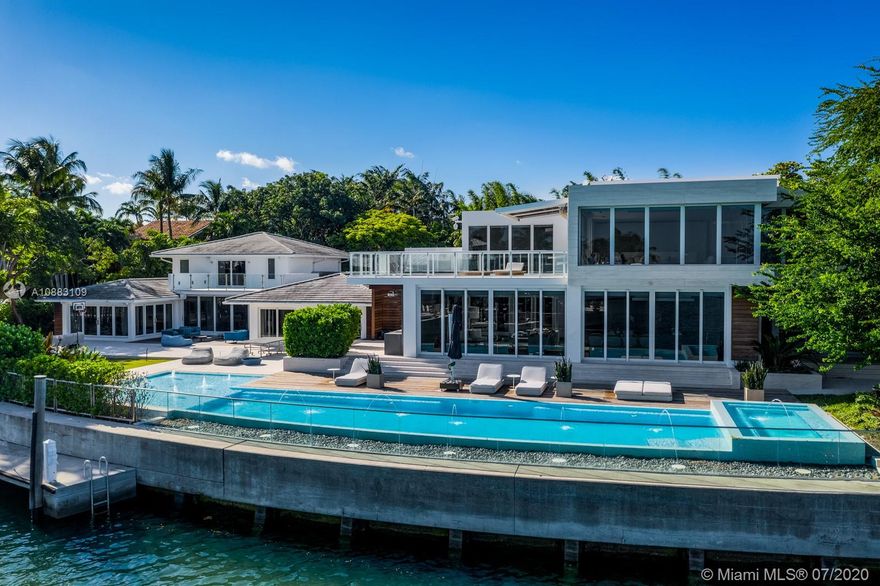 Incredible waterfront mansion on a rare point lot offering direct ocean access - Two lots combined Rebuilt in 2015. This high-end construction is extremely private & sits on almost an acre of land,providing for expansive views over the water and the Florida State Park.The property is a true boater's dream with 200 SF of water frontage,2 boat docks & a new seawall.The completely gated mansion offers 7 beds,9 baths & the highest level of finishes.Notable features include:3 reception areas,formal dining,over-sized master suite w/superb views & spectacular master bathroom,2 large custom walk-in closets,completely equipped state-of-the-art media room,glass wine cellar,4-car garage & advanced security system. This property also offers a pool,gym area with sauna, steam room & tatami "study" area.
