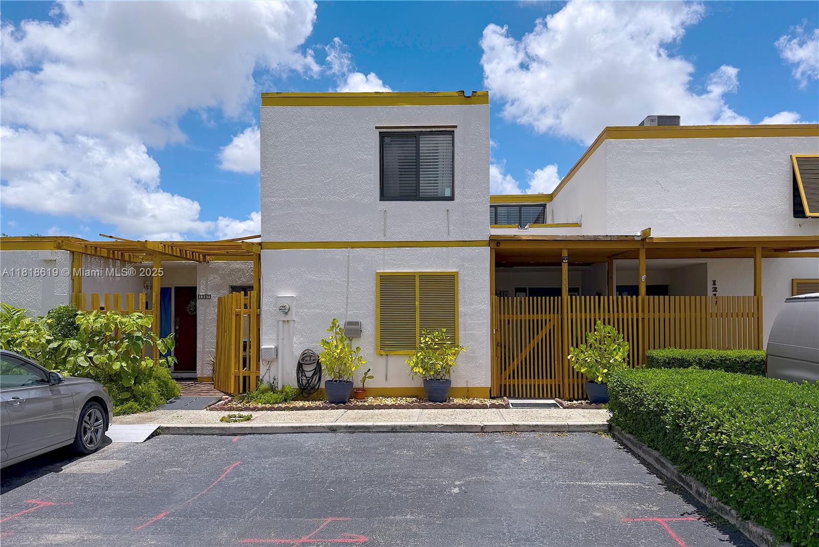 This move-in ready, completely remodeled 3-bed, 3-bath townhome is the largest layout in the community, featuring direct lakefront views facing east for sunrises without the harsh evening sun. The unit is updated throughout with porcelain tile flooring, floor to ceiling sliding glass doors, new AC, and hurricane impact windows and doors. The kitchen has been completely redesigned, opening it up with a beautiful island while wooden vaulted ceilings add a warm touch. The upstairs master bedroom features a spacious walk-in closet while downstairs there's a conveniently located full bathroom and bedroom for guests with ample storage under the staircase. Resort-style amenities include: pool, courts, 24-hour security. Prime location near FIU, Turnpike, restaurants, shopping. Low HOA fee