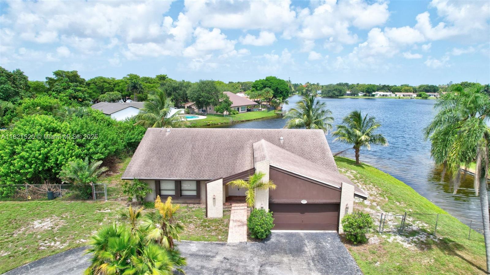 Lakefront Paradise with Sunrise Views! Discover this charming 3-bedroom, 2-bath home perfectly positioned on an oversized 14,300+ sq ft lot great for RV/boat storage. Incredible 240 feet of lake frontage. Over 2000 sq ft under air. Features vaulted ceilings and an open layout, w/ tons of natural light. Circular driveway offers plenty of parking, while the spacious backyard provides endless potential for outdoor living. Roof (2018). Renovated kitchen & bathrooms. Indoor laundry room. Centrally located just minutes from 595, FLL Airport, Fort Lauderdale beaches, and walking distance to schools, parks, and a local dog park — this is a rare opportunity to own a lakefront property in a prime location. No HOA!