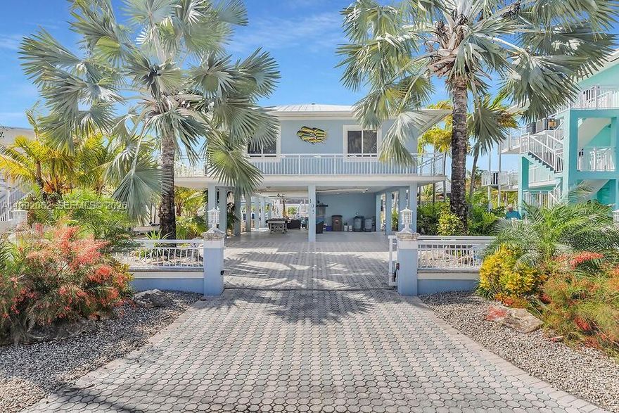 Immaculate Waterfront living MM102 Oceanside. Renovated 3BR/3BA concrete residence in Key Largo delivers the ultimate boating lifestyle w/ 60' of composite dockage, 15,000 lb boat lift, direct ocean access w/bay access via Adams Cut placing world class fishing, diving, & cruising just minutes from your dock. Inside, open-concept design quartz waterfall countertops, stainless appliances, custom bar w/wine cooler, impact windows & doors, w/refined finishes throughout. Two private en-suite bedrooms offer elevated comfort w/spa-like baths & custom closets.Step outside to your private resort setting, a shaded patio with summer kitchen & hot tub perfect for entertaining after a day on the water. For the strategic buyer, this property also offers 28-day minimum rental, creating an opportunity for luxury seasonal income. Boat all day. Entertain all night. Wake up and do it again. Anchor in Paradise!