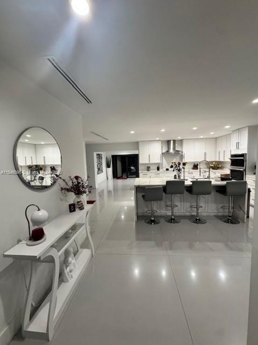 This stunning 3-bedroom, 2-bathroom home offers a tranquil lake view and an expansive outdoor area with a magnificent deck, perfect for relaxing or entertaining. This well-appointed residence features spacious bedrooms with walk-in closets, a laundry room, and a comfortable family room ideal for everyday living. The tastefully renovated bathrooms, stone countertops, and stainless steel appliances add a modern and elegant touch. Located in the heart of Hialeah, this home combines convenience with comfort in a peaceful lakeside setting.