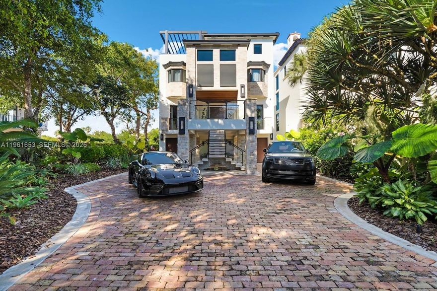 Introducing Seaglass Pointe, Luxury Waterfront Living Redefined. Thoughtfully reimagined from the ground up, Seaglass Pointe is a one-of-a-kind luxury waterfront residence where exceptional design meets extraordinary water views from every level. This fully redesigned home offers over 5800 sq ft, 3 bedrooms & 5.5 baths, with the flexibility to easily convert back to a 4-bedroom layout. Each bedroom is a private ensuite with walk-in closets, creating a retreat-like experience throughout the home. No detail was overlooked from impact windows & doors & a newly installed metal roof to all-new plumbing, electrical, A/C systems & a private elevator servicing every floor. The chef’s kitchen, outfitted with top-of-the-line appliances, flows seamlessly into expansive living & entertaining spaces designed to embrace the surrounding water views. Outdoors, a heated pool & TWO private boat slips directly behind the residence create the ultimate South Florida boating lifestyle. The crown jewel is a spectacular rooftop entertaining level featuring indoor–outdoor living & a temperature-controlled glass wine cellar, the perfect setting for sunset gatherings overlooking the water. Located within a prestigious guard-gated waterfront community, residents enjoy resort-style amenities including a private sandy beach, tennis/pickleball courts, clubhouse, gym, heated pool/spa, nature trails & a scenic waterfront boardwalk. Seaglass Pointe is more than a home — it’s a statement in waterfront living.