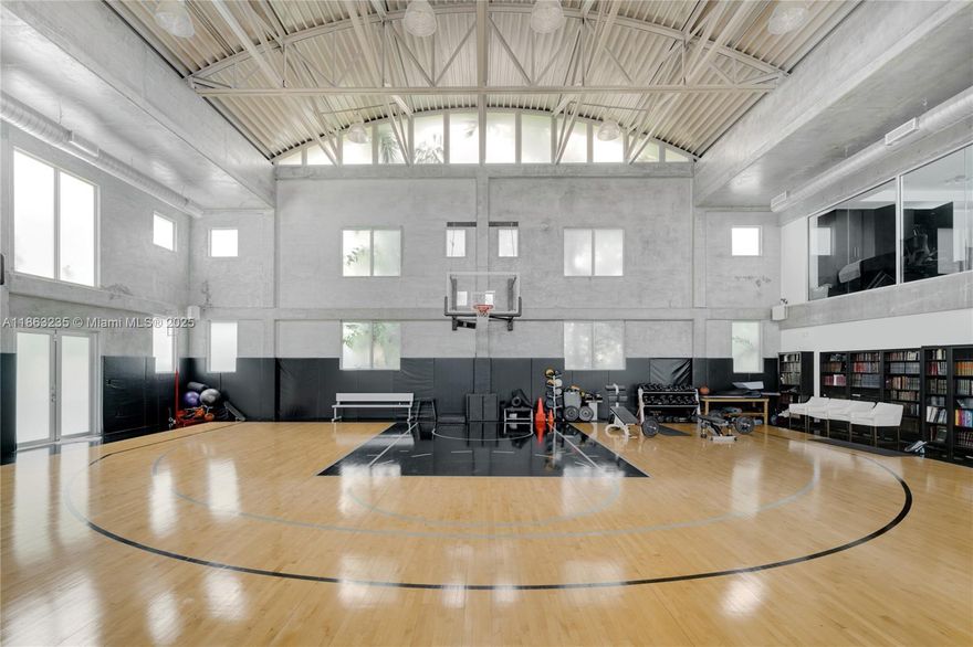 Live like an MVP. This modern 2-bedroom, 2-bath Miami Beach home puts a state-of-the-art indoor basketball court at the center of over 5,000 sq. ft. of loft-style living. The court can easily transform into a padel court, private gym, or any space you imagine. Entertain in style with an open-concept design, a sleek chef’s kitchen, and a pool made for post-game relaxation. Set on a 13,787 sq. ft. lot, this bold residence delivers luxury, lifestyle, and endless possibilities.