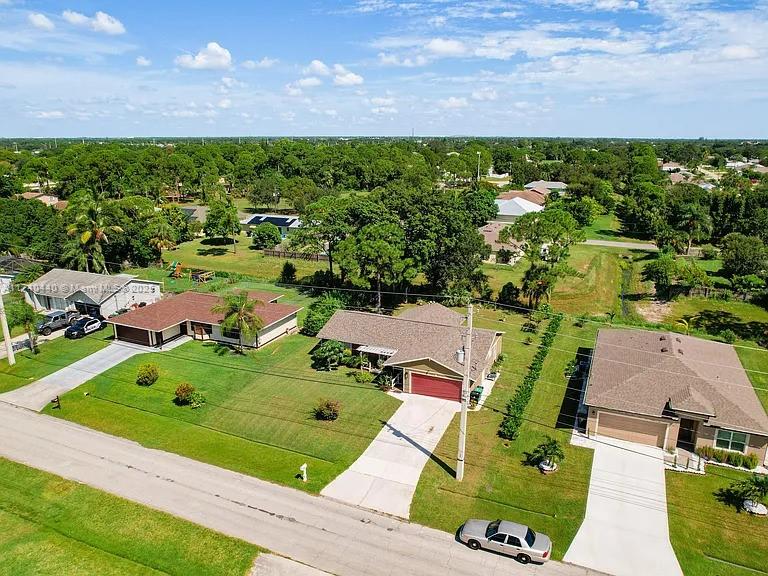 This updated 3-bedroom, 2-bathroom home in Port St. Lucie boasts a durable 2021 roof. The spacious yard provides ample outdoor space, while the enclosed lanai offers the perfect spot to enjoy the Florida weather. Inside, you'll find a remodeled kitchen featuring modern finishes and an island, complemented by an open layout ideal for family gatherings and entertaining. The primary bedroom includes an ensuite bathroom for added convenience. Don't miss out on this stylish and comfortable home in a fantastic location!