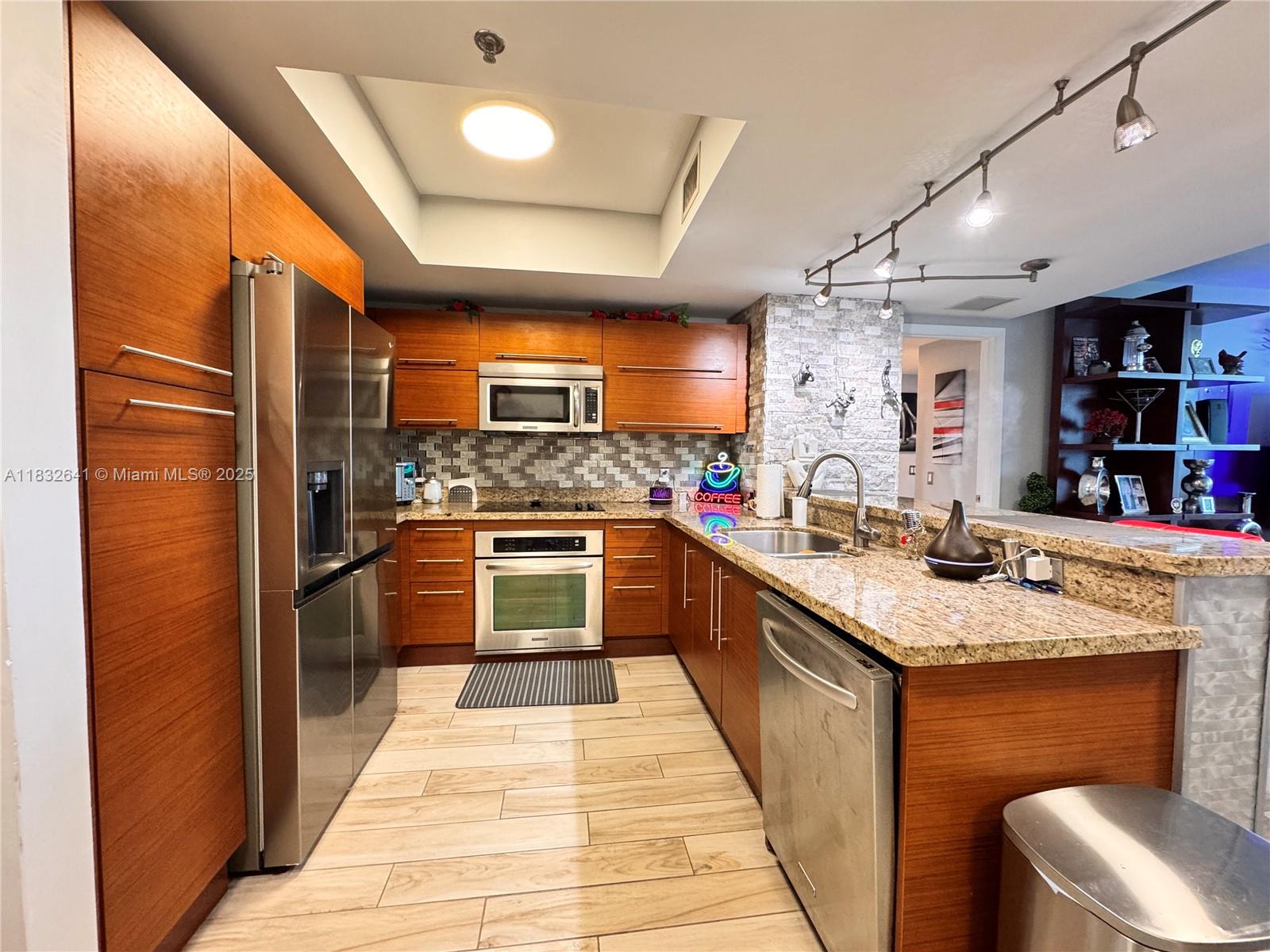 Experience luxury living at Tao Sawgrass in this beautifully upgraded 2-bedroom, 2-bath condo. This residence features elegant wood-look porcelain tile flooring throughout, a stylish open kitchen with granite countertops and stainless steel appliances, spacious bedrooms with walk-in closets, and modern bathrooms. The expansive balcony offers breathtaking panoramic views of the pool, serene lake, and the Everglades, making it the perfect place to enjoy stunning sunsets every evening. The unit also includes 2 assigned parking spaces. Tao Sawgrass is a full-service high-rise offering resort-style amenities, including an state-of-the-art fitness center, sauna, tennis court, clubhouse, business center, and 24/7 security. Ideally located just steps from Sawgrass Mills Mall.