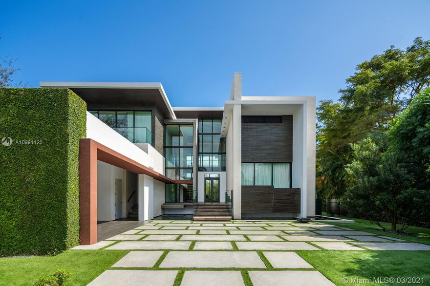 Enjoy the best of Both Worlds in this Miami Beach Modern in Coral Gables’ gated amenity-rich Islands of Cocoplum.Both glamorous & casual,best design & finishes are flawlessly executed.Limestone & Italian wood floors,marbelized walls,Boffi kitchen,Handcraft millwork & built ins,Element lighting,matt-glazed oxidized steel cabinet & room divider pivot doors,hand painted+Moroccan tile accent the soaring ceilings & views of the edgeless pool,deck & lush waterfront through floor to ceiling glass.2/2/1 downstairs includes a staff or guest suite. Dreamy master suite,w Polyform closets,spa bath+terrace.Addtl 2/2 upstairs share 2nd family room.Outdoor areas are big on PRIVACY,w covered terraces,wood & glass-railed decks,summer kitchen,ample green areas,private dock. playroom+media.Elevator/Generator