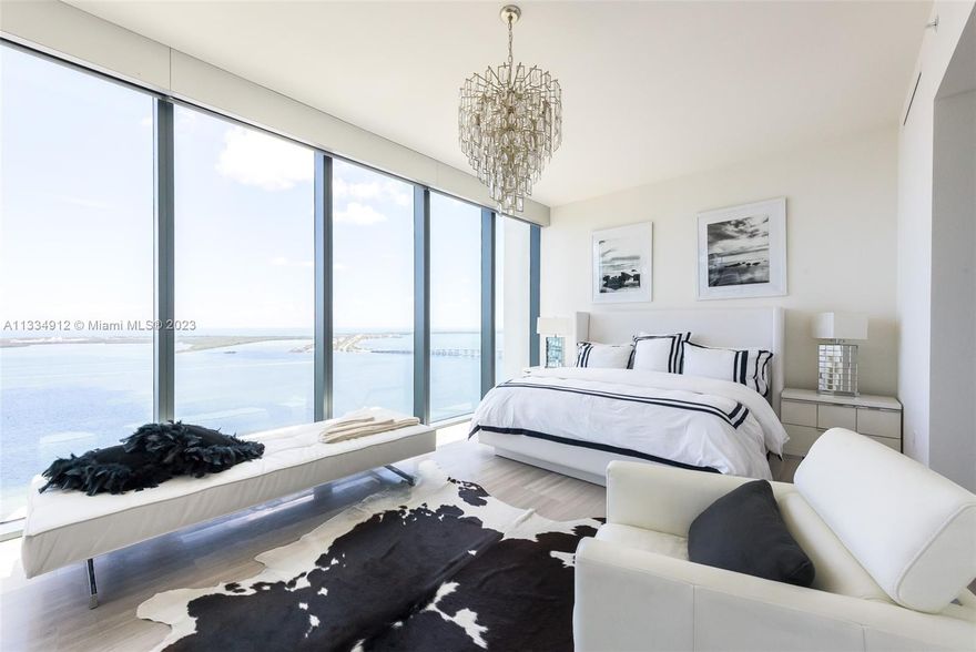 Corner 2 bedroom + den & 3 full baths. One of three units on its floor with this unit being the only one on its side providing extra privacy. Stunning unobstructed water and city views. Two parking spaces. Exquisitely designed with breathtaking panoramic views from every room. Summer kitchen perfect for entertaining on your 8 foot deep terrace and second wrap around balcony from main to second bedroom. Fully functioning pool bar. In-house chauffeur services & on call dog walkers.