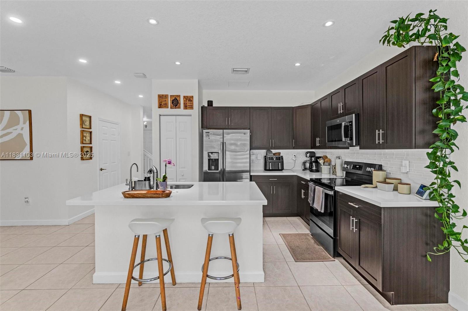 Up to $5,000 toward buyer’s closing costs with full-price offer.There’s a rare kind of peace you feel when you walk into a home designed for comfort and connection. This upgraded 4 bed / 3.5 bath townhome in Aquabella by Lennar sits on a quiet street near the Miami-Broward line, one of Hialeah’s most connected and growing corridors. With no rear neighbors and easy 100th St. access, it offers privacy and ease. Upstairs, the primary suite features a double-vanity bath, while a second bedroom also enjoys its own private bath, a rare find that adds flexibility for family or guests. Smart lighting, cameras, keyless lock, tile and laminate floors, travertine patio. The garage retreat with epoxy floors and built-in bar invites fun. Pools, clubhouse, gym, splash park, more than a home, your reset.