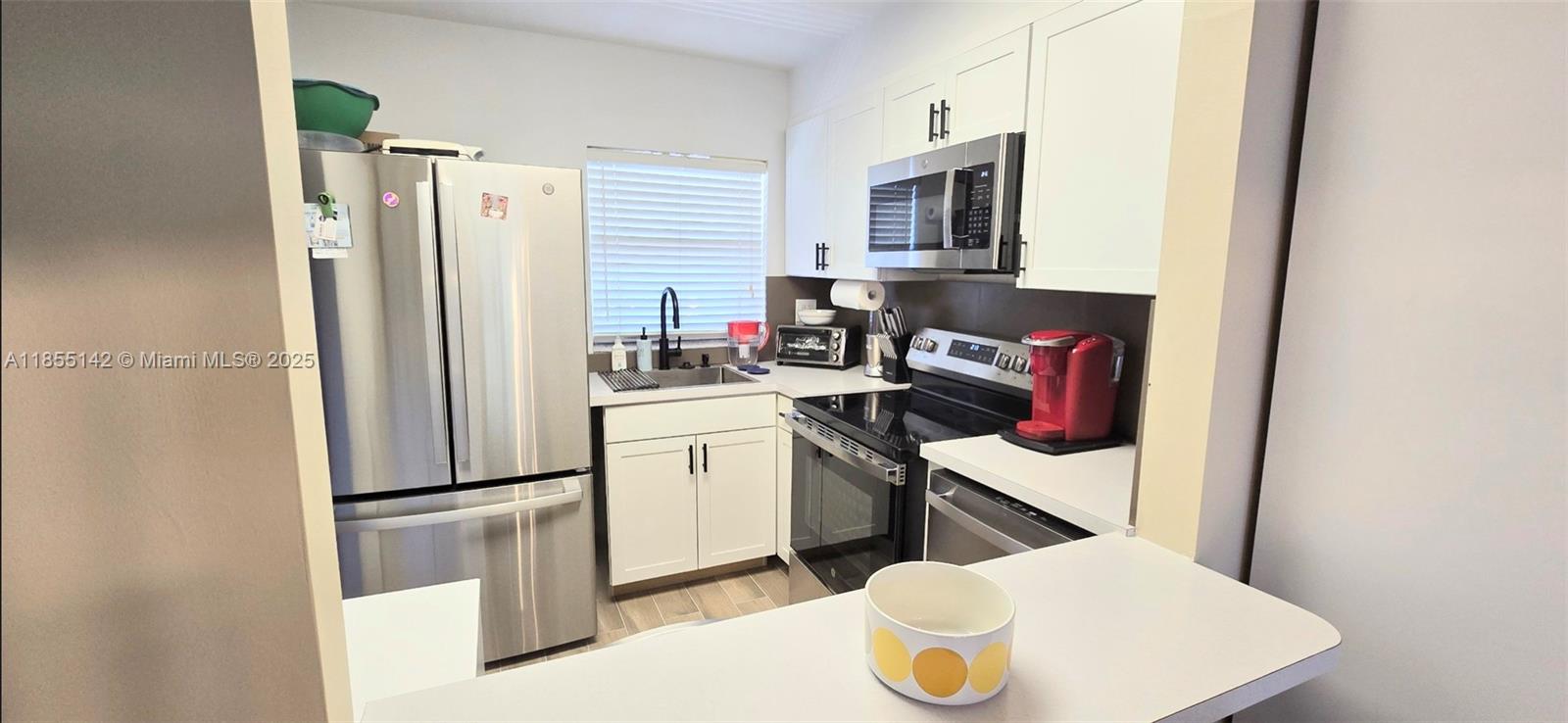 Welcome home to this completely remodeled 3rd floor unit. It will be hard to find a more modernized unit. Brand new kitchen with stainless appliances including DISHWASHER. New cabinets, countertops and large pass thru to dining room. Porcelain tile thru-out, including closets. Beautiful bath with new vanity, toilet, shower body and all fixtures. Enjoy coffee or wine on your enclosed patio with wonderful lake view. Unit has closets galore including a large walk-in closet in your over sized bedroom, and additional storage unit just steps from the unit. Laundry and elevator are also close. Sunrise lakes offers many amenities such as pools, golf, pickleball, and shuttles to shopping, doctor and nearby casinos! You will love living here. Photos in listing are staged. Furniture does not convey.