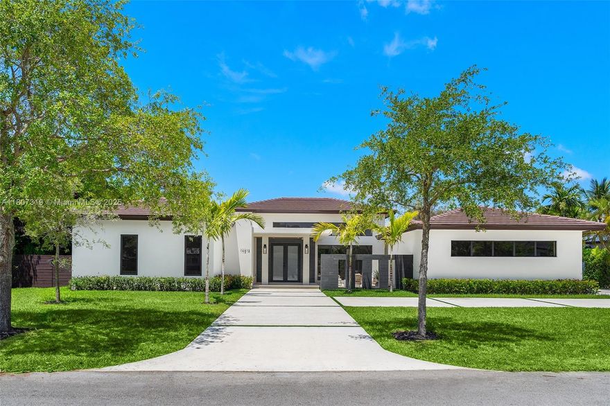 Brand new Tropical Modern estate by one of Palmetto Bay’s most longstanding and respected builders. This 5,060 SF home boasts high ceilings, wall-to-wall impact windows, and seamless indoor-outdoor living. Outdoors, enjoy a resort-style pool, BBQ-ready covered terrace, and great yard for fun in the sun. Inside, the open chef’s kitchen is complete with Frigidaire Professional appliances (incl. gas range & column refrigeration), custom cabinetry, modern finishes, and a large kitchen island w/ quartz countertops. Four ensuite bedrooms include a tranquil primary suite with spa-inspired bath and pool views while 5th bedroom could serve as office or gym. Finally, the fantastic laundry/mud room, oversized 2-car garage and “X” flood rating provide peace of mind and lots of space for storage.