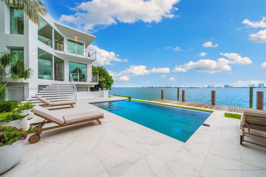 Exquisite Waterfront Villa with Stunning Bay Views
Nestled on an oversized 15,000 SQ FT lot with over 150 feet of open bay frontage, this exceptional villa offers breathtaking panoramic views of Downtown Miami, Miami Beach, and Edgewater. Enjoy both sunrises and sunsets from this prime location. This spectacular 6-bedroom, 7-bathroom residence features a maid’s quarter, private gym, theater, and elevator. The master suite spans over 1,000 SQ FT, complete with a steam room and an expansive 1,000 SQ FT private terrace—a true retreat of luxury.Located in the serene neighborhood of Miami Shores, just a few blocks from Miami Country Day School, this home offers a private dock with space for a 60-foot yacht.