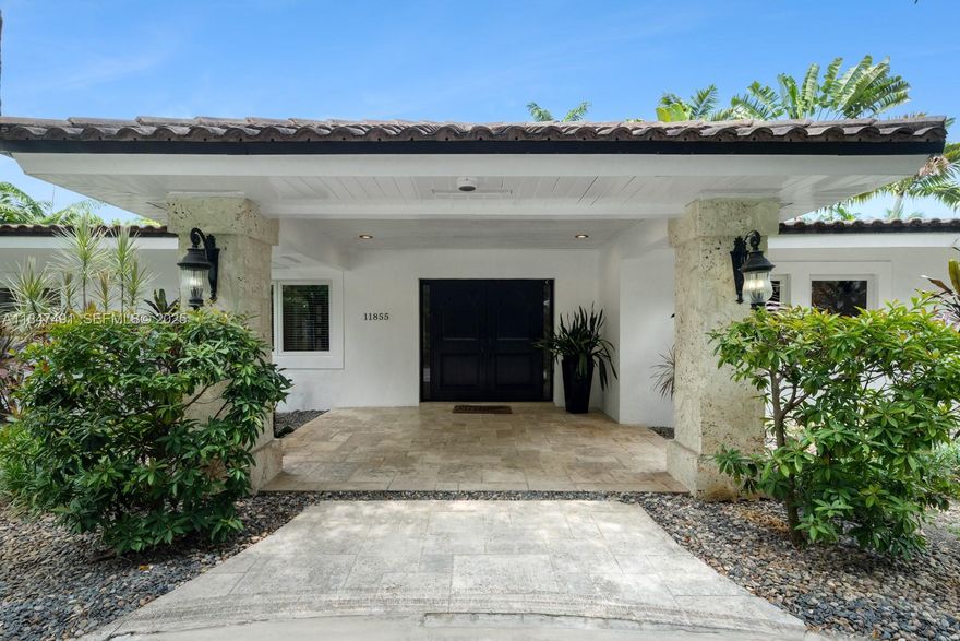 Experience elevated living in this gated one-acre Pinecrest estate. 4235 SF Living Area. Fully updated plumbing and electrical, tropical retreat boasts resort-style pool with jacuzzi, guest house with cabana bath, and lushly landscaped grounds. Inside, discover magazine-worthy interiors with refined millwork, soaring ceilings, 24x48 marble floors, and solid wood in all bedrooms. Impact windows and doors bathe the home in natural light. The 5-star gourmet kitchen features top-tier appliances, dual Wolf gas ranges, and a grand center island beside a sleek bar—ideal for stylish entertaining. Luxe primary suite offers dual closets and a spa-like bath with steam shower. 3 place carport, circular driveway, and generator all on one of the best streets in Pinecrest complete this perfect package.