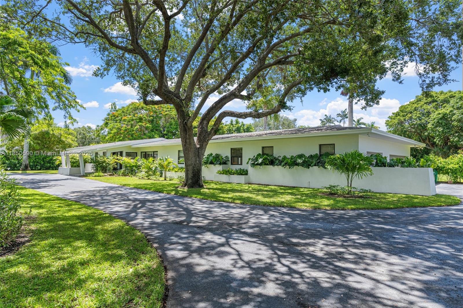 Experience charm and comfort in this tastefully updated Pinecrest residence offering 7,000 sq ft, on a lush 39,204 sq ft lot (a builders acre). Nestled among mature tropical landscaping, this home features 6 bedrooms, 6.5 baths, a seamless layout w/ expansive living areas & views of the beautifully landscaped yard & pool. A few of the highlights include Spanish gray tile flooring, classic wood kitchen cabinetry with black granite countertops, travertine bathrooms, a 1,600 sq ft primary suite w/office & an oversized closet. Enjoy a large covered terrace, 3-car garage, sauna, two laundry rooms, impact windows & doors, and more. Fully fenced & privately situated on a quiet, desirable street in the Village of Pinecrest — this is a rare opportunity to own a truly exceptional home.