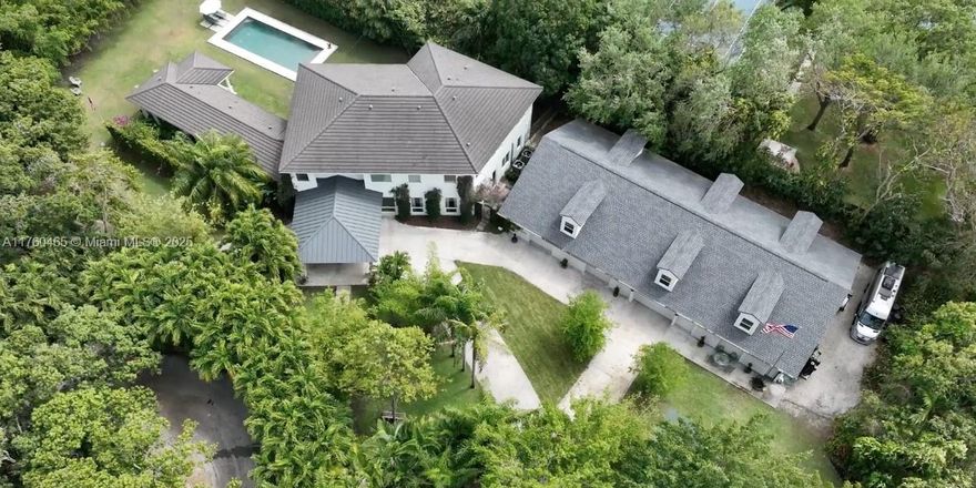 Private Northeast Palmetto Bay home, newly built in 2021 offering seclusion, security and seamless indoor-outdoor living. Near top rated schools, parks and local amenities, perfect for families and professionals alike. Bathed in natural light with oversize windows, this home features high ceilings, wood floors throughout, modern amenities and a private primary suite with patio. Outdoors you will find a resort style backyard and pebble-Tec pool, a basketball/pickle ball court and plenty of green lush space. Sitting on an expansive 38,000 sq. ft. lot, this property offers an additional 1,100 sq. ft. living space above a 3,000 sq. ft. garage. Total living area to 8,493 sq. ft. of private estate living. Don’ t miss seeing this rare opportunity–schedule your private showing today!