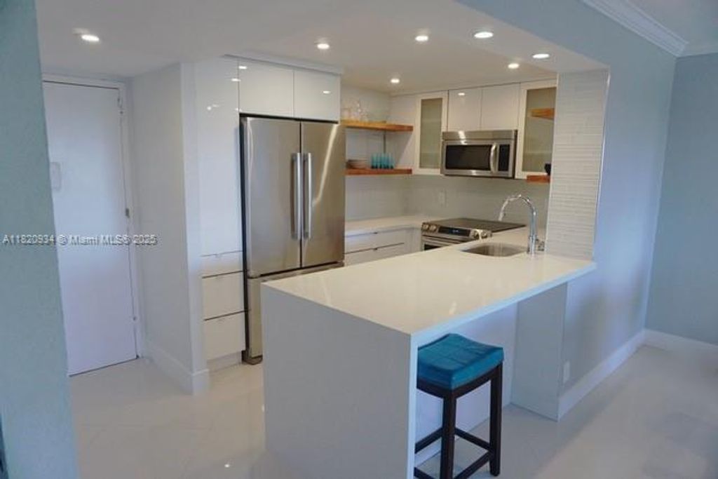 Photo of 401 Golden Isles Dr #1006, Hallandale Beach, FL 33009 (MLS # A11820934)