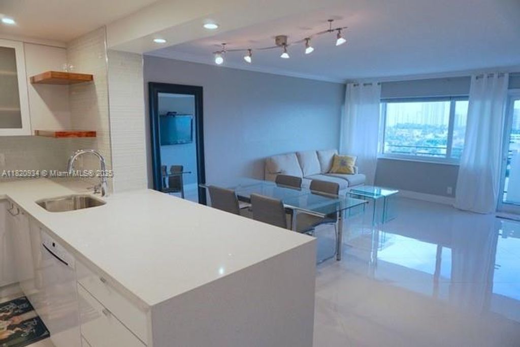 Photo of 401 Golden Isles Dr #1006, Hallandale Beach, FL 33009 (MLS # A11820934)