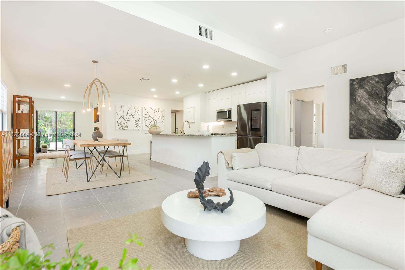Incredible modern 3-bedroom, 2-bath home offers luxurious living with a spacious open layout bathed in natural light, sleek finishes, and extraordinary outdoor space. The gourmet kitchen features high-end appliances, a large granite island, and ample cabinetry. Large bedrooms equipped with custom built-in closets. Step outside to a beautifully landscaped backyard with a huge avocado tree and lush canopy, perfect for outdoor gatherings. Enjoy the convenience of a Tesla charger. 

Situated in a safe, quiet neighborhood across from an elementary school, with no front neighbors for added privacy. Close to Biscayne Blvd, beaches, and major stores. This must-see property is ready to welcome you home!