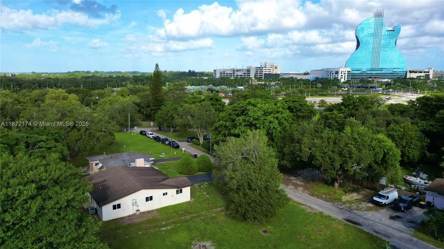 View from the HARD ROCK! Don't miss this unique 4 bed, 3 bath home featuring a permitted carport conversion that functions as a fourth bedroom or separate unit, perfect for rental income via Airbnb or multi-generational living (in-law suite). Enjoy peace of mind with a new shingle roof and doublewide driveway (both 2022), impact windows and doors throughout, and no HOA restrictions. Sitting on a large lot with room for a pool and/or storage for a boat or RV, this property offers both comfort and future potential. Prime location with a front-yard view of the Hard Rock Hotel & Casino. Close to major highways, easy access to main roads, and conveniently located near a variety of community centers and gathering places. A rare opportunity for homeowners and investors alike!