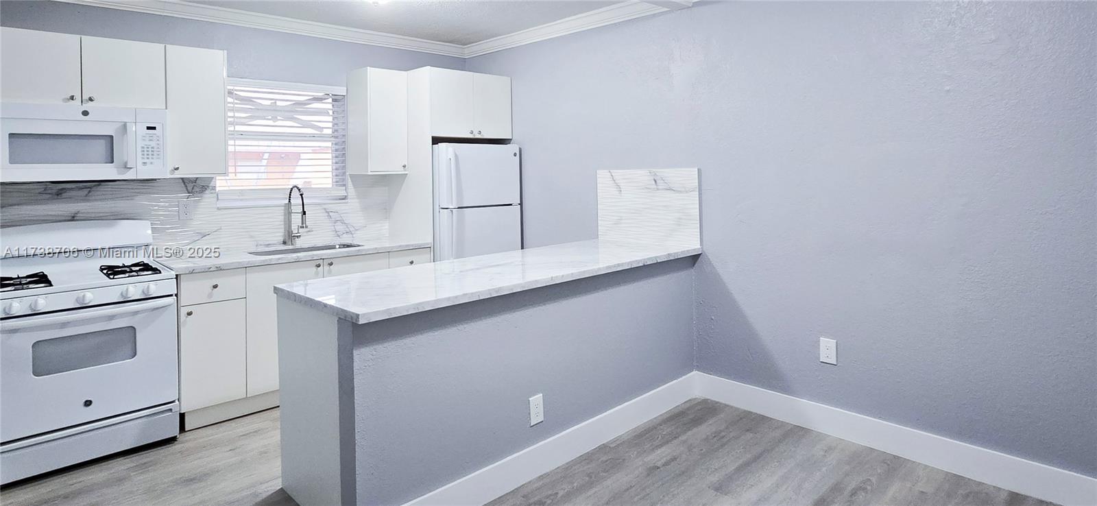 Apartment Available in Bella Luna Community! This fully remodeled 2-bedroom, 1-bath unit includes water and gas. It features brand-new wood laminate flooring, a renovated bathroom, a modern kitchen with granite countertops, new cabinetry and appliances, and a newly installed A/C. Located on the first floor, it comes with an assigned parking space and plenty of visitor parking. The owner does not allow pets. Additionally, the building offers convenient laundry facilities. Move-in ready!