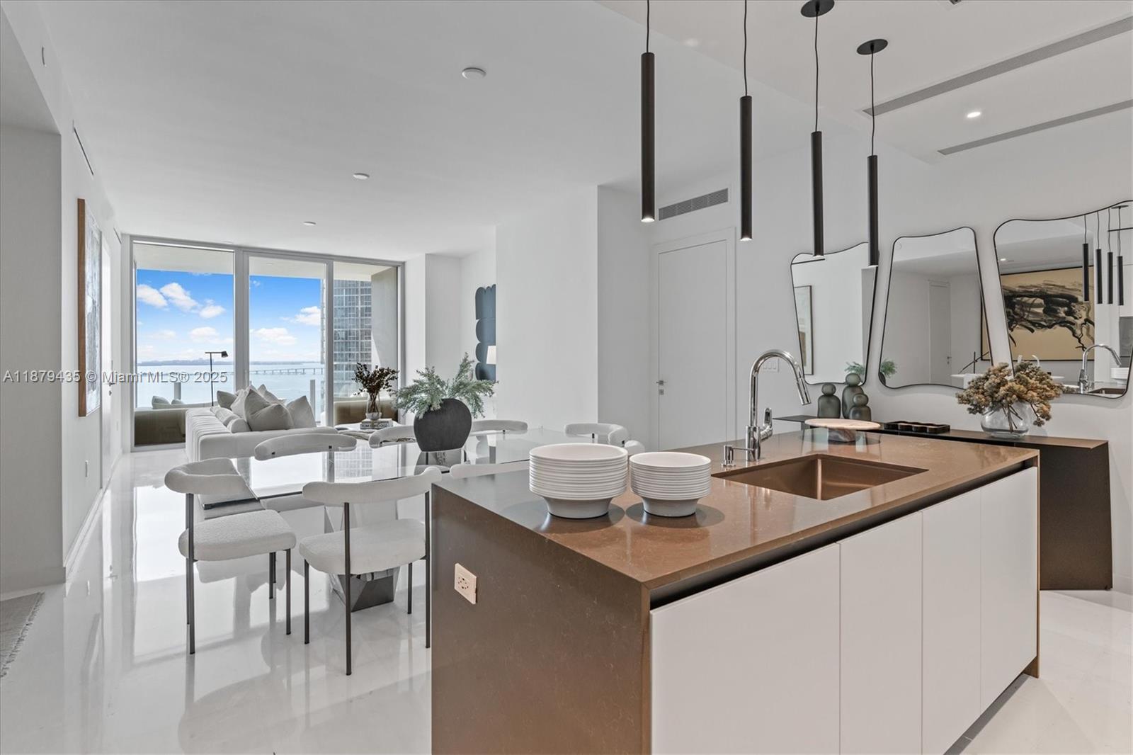 Refined living at Aston Martin Residences with breathtaking water views of Key Biscayne and Brickell Key. This residence includes a spacious conv. den with a closet, a Bulthaup kitchen featuring Gaggenau appliances, and spa-like bathrooms with Duravit sanitary ware and Axor fixtures by Philippe Starck and Antonio Citterio. Natural stone flooring, 10-foot ceilings, and three lift-and-slide units by Schüco fill the home with elegance and natural light. Residents enjoy 42,000+ SF of lux amenities, including an infinity-edge pool, fitness center, spa, and concierge services. Perfectly situated in Miami’s Brickell area, this home embodies luxurious waterfront living. Schedule your private tour today!