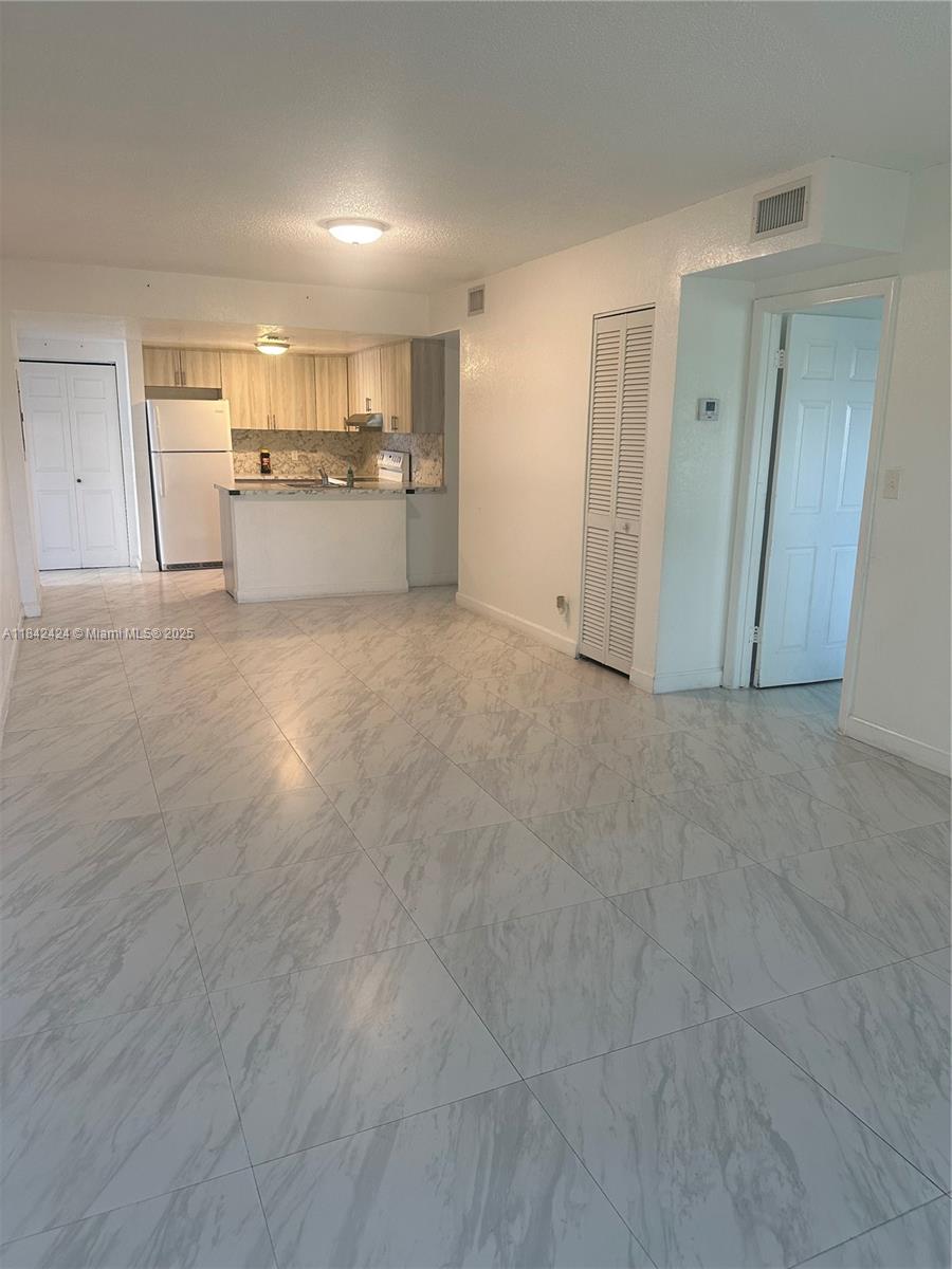 Spacious 2-bedroom 2-bathroom corner apartment features hurricane impact windows, patio, laundry facilities, tile floor, near shopping centers, and schools. MUST SEE!