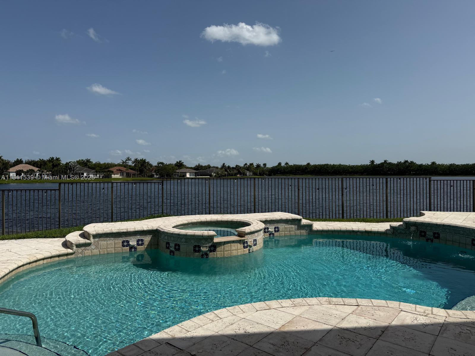 Amazing lakefront view from this beautiful two story home complete renovated with five bedrooms and four full renovated baths. This home is located in the gated community of The Island on a pie shape lot with lots of room to entertain friends and family. Sparkling pool with jacuzzi on the backyard and the most stunning views of the lake from the master suite and balcony. New roof, New and renovated kitchen, New impact windows, electric curtains, wine cooler, walk in pantry. Four bedrooms and three bathrooms upstairs and a fifth bedroom currently used as an office and full cabana bath downstairs.
