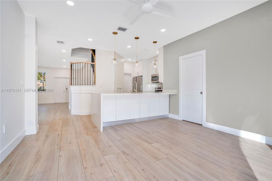 PRICE IMPROVED - SELLER MOTIVATED - MOVE-IN READY This beautifully updated 3-bedroom, 2.5-bath townhome in the highly sought-after gated Nautica community offers a bright and open layout filled with natural light, a modern interior with wood-look flooring throughout, an elegant staircase, designer lightning, a stunning white kitchen featuring a quartz waterfall island and stainless steel appliances, and a NEW AC (2023). Enjoy a private fenced patio with palm trees perfect for outdoor gatherings. Upstairs you’ll find a spacious primary suite with two walk-in closets and en-suite bath with dual sinks, two additional bedrooms (one with walk-in closet and one with built-ins) and a laundry space with washer and dryer (2023). Window treatments and ceiling fans. Located in a secure guard-gated community with resort-style amenities and a low HOA of just $294/month. Zoned for highly rated schools and conveniently close to shopping, dining, parks, and major highways for easy commuting.