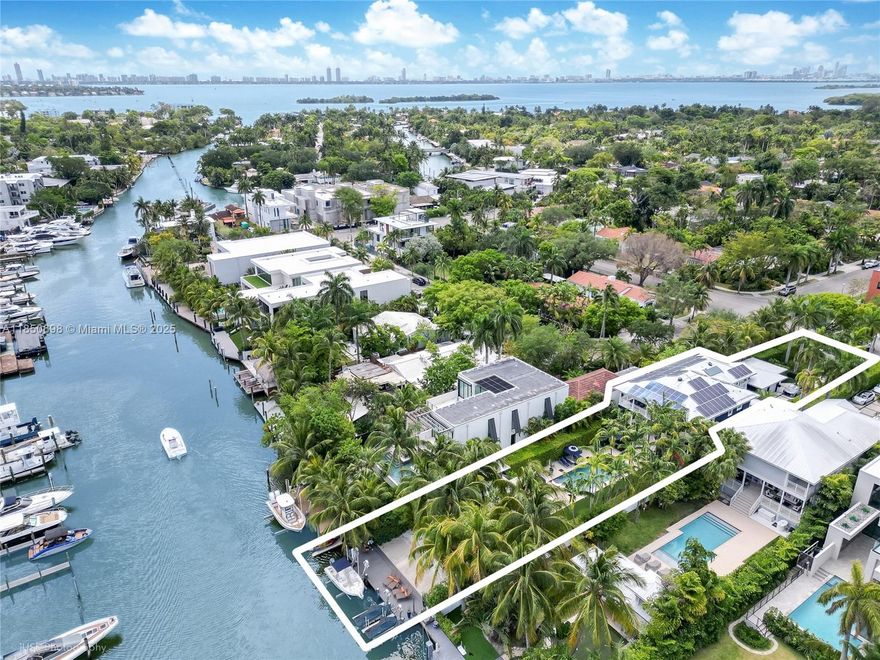 Renovated, elevated, and gated waterfront estate in guard-patrolled Belle Meade. This 4BR/4BA home spans 6,093 SF total on a 17,350 SF lot with deep water, no-bridge bay access. Features include a 10-car motor court, a 7.5-ft pivot door, a 21-ft foyer, 11-ft ceilings, a custom Wolf/Sub-Zero kitchen, a walk-in pantry, an indoor-outdoor wet bar, and backlit marble accents. Enjoy a 40x15 heated saltwater pool, gazebo with summer kitchen and cabana bath, plus an elevated seawall and dock with boat + dual Jet Ski lifts. Energy-efficient with 77 solar panels, two new 5-ton ACs, a whole-house generator, impact glass, Lutron lighting, and a full smart security system.