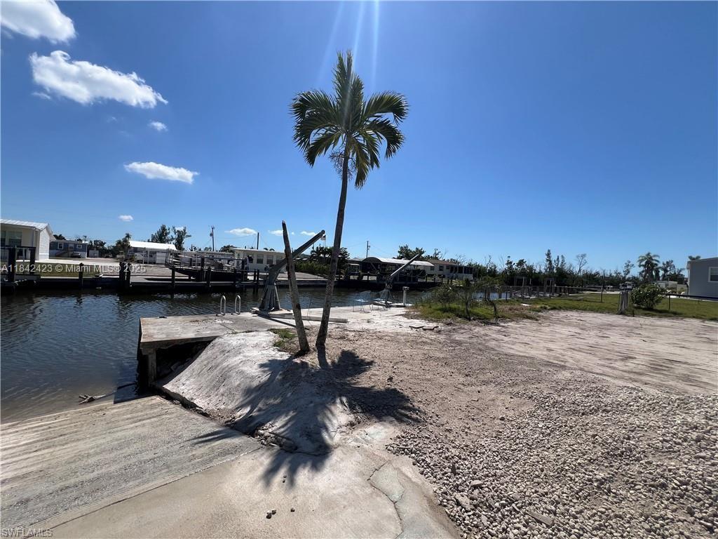 This canal-front vacant lot is ready for your mobile or modular home and offers a laid-back coastal lifestyle in one of Pine Island’s most charming neighborhoods. The lot includes a seawall, private dock, cement patio dock, and a storage shed already on-site, making it the perfect setup for boating and waterfront living. Located at the far west end of Flamingo Bay, this property is just minutes from Pine Island Sound, providing quick and easy access to open water for fishing, boating, and exploring. St. James City is well-known for its relaxed atmosphere, friendly neighbors, and incredible access to nearby destinations like Sanibel, Captiva, and Cayo Costa. The property is part of a voluntary HOA, $275 per year, you’ll enjoy access to the community pool, clubhouse, and boat ramp.