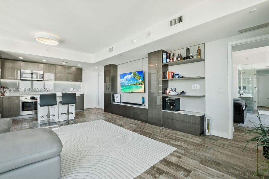 Paraiso Bay-Edgewater Miami Waterfront District: Beautifully remodeled 1-bedroom, 1.5-bath turnkey furnished corner residence with dramatic bay views and exposures to both the East and northwest. This impeccably designed unit features new full-wall custom built-in cabinetry with entertainment center and bar, a new kitchen island and cabinetry, custom wall finishes, recessed lighting and power blinds throughout. Includes one assigned parking space, plus optional valet services with ten (10) eight-hour visitor passes per month.

Paraiso Bay is part of the Paraiso Bay Master Association and offers an unparalleled lifestyle with a spectacular two-acre amenity deck highlighted by a 100-foot diameter circular resort-style pool surrounded by lush landscaping, private bungalows, poolside dining, and towel service. Residents enjoy three full floors of world-class amenities, including tennis courts, bowling alley, multiple indoor and outdoor kitchens, putting green and golf drive simulator, game and club rooms, cigar and wine lounges, state-of-the-art fitness center, indoor and outdoor spa, private theater, Pilates and yoga studios, curated classes, and vibrant community events.