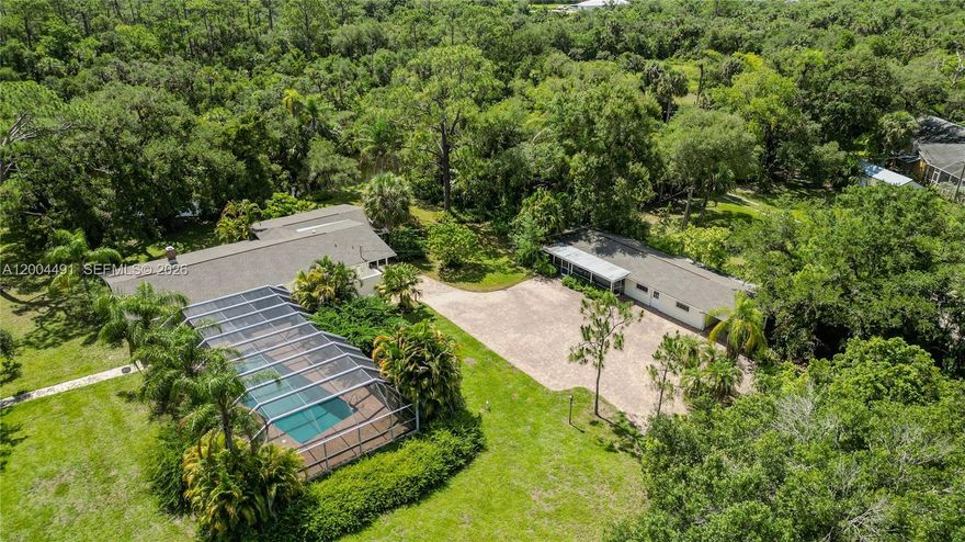 This is a truly remarkable property that photographs can't do it justice. Such a beautiful oasis!! Private, peaceful,…Perfect for an Artist, writer, photographer or just a nature lover! The good life awaits!! Multigenerational property 2 home estate. Enjoy the workshop/barn of the 2400sf red iron/steel barn. Enjoy the screened recreational area with 40ft pool. Located on 344 feet of the navigable Telegraph Creek, 550 yards to the Caloosahatchee river. Feel the privacy in this 3.2 acre estate. ZONED AG 2! Mature oaks & pines, find yourself in the secret, equestrian and recreational Hideaway of Alva, Florida! The tranquility and elegance of this 3.2 acres rich in classic southern style charm. Nestled in mature native yellow pines dripping with Spanish moss, Sable, cabbage, palms and tropical fruit trees, it borders the West Bank of Telegraph Creek at the distal end near the Caloosahachee river. The serene privacy of Florida is found in this estate beginning with the inviting entrance design that enhances the aesthetic appeal of this property.
DETAILS: Main house is 2422sf 3/2 with grand open spaces. see additional remarks