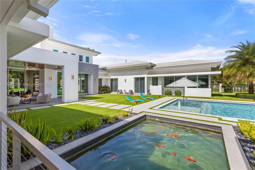 Owner Financing Available for this South Florida home built in 2021 on a full Acre. It offers 6bed and 6.5baths. Built at a natural 14ft elevation, it has poured concrete roof with great insulation and built-in gutters. It has top of the line impact windows & doors. Homeowners insurance is a fraction of average cost. It is connected to the Natural Gas grid, to power water heaters, dryer, pool heater, stove, BBQ, accent Tiki Torches & a whole house generator. It is an intelligent home with a state of the art camera security system and an incredibly efficient 21-tons A/C. The pool, hot tub and summer kitchen are a work of art, and the Koi pond a mesmerizing feature between the guest house and the main. A resort like environment that you will want to run to in the event of a hurricane.