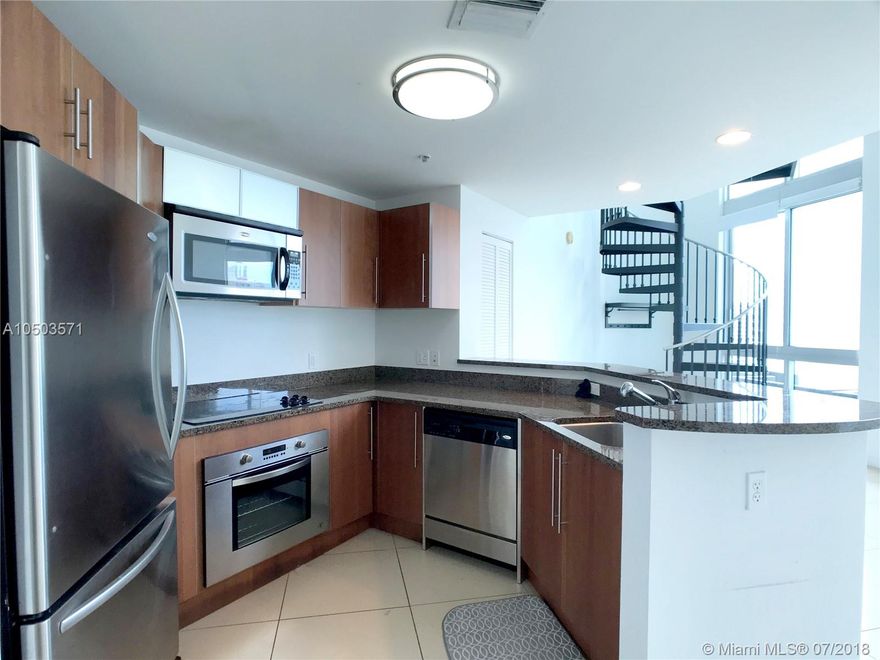 Beautiful 2-Story loft with stunning water and city views, white porcelain flooring throughout and double height ceilings with 1 bedrooms and 1.5 bathrooms. located on the 12th floor of this luxurious High Rise in the heart of downtown. Walking distance to whole foods, shopping malls, retail stores and the best restaurants in Miami. Enjoy resort amenities in this building such as lobby attended 24-7, valet parking, pool, hot tub, Gym and much more