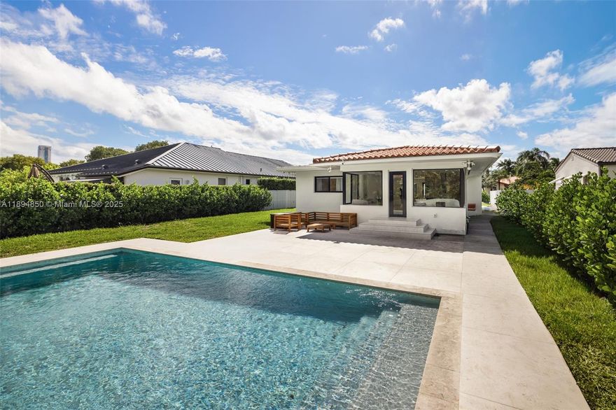 Elegantly remodeled, this stunning 3-bedroom, 2-bath residence in The Roads blends refined design with everyday comfort. Sunlit interiors feature porcelain floors, impact windows, and a chef’s kitchen with custom cabinetry, premium appliances, and an inviting eat-in island. The spacious bedrooms include built-out closets, and the bathrooms are finished with sleek, modern details. Outdoors, enjoy a saltwater pool surrounded by lush landscaping, a large patio—ideal for entertaining and relaxing in total privacy. Set on a quiet, tree-lined street within walking distance to top-rated schools, Brickell and minutes from Coconut Grove, and Key Biscayne, the home includes a garage, two driveway spots, and ample street parking for guests.