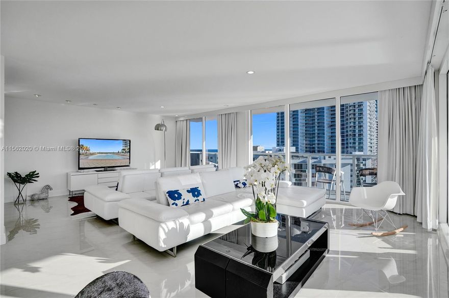 Experience the breathtaking sunrise and sunset views from the largest penthouse in the community, offering ocean and bay vistas from every room. The expansive wraparound terrace, equipped with floor-to-ceiling windows, provides an ideal setting for seamless indoor-outdoor living. Boasting a complete renovation with numerous enhancements, this exquisite property now features a maid's quarter, high-impact windows, and more. The recently renovated Aquarius complex provides a range of amenities, including two pools (an infinity pool overlooking the ocean and a pool for sunset views), a fitness center, a beauty salon, a game room, a sauna, beach access, and service, valet parking, covered parking, 24-hour security, an Italian restaurant with outdoor seating, and additional delights.