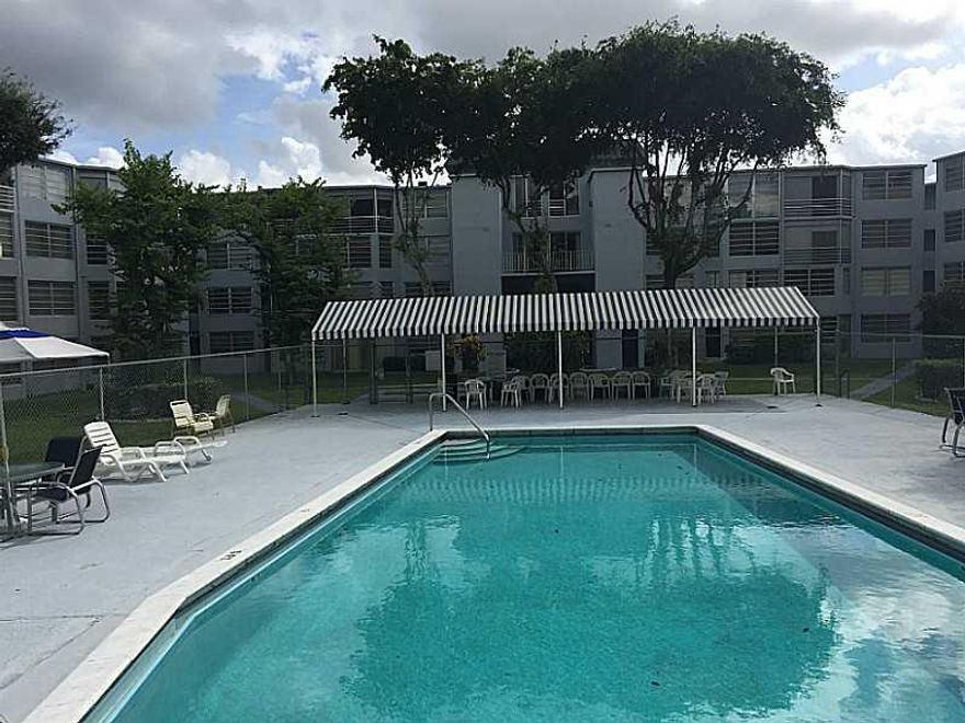 OWNER FINANCING WITH SUBSTANTIAL CASH DOWN!--terms negotiable.Upgraded, spacious, first floor corner unit features new kitchen, new bathroom vanities, new tile throughout. Freshly painted with extra windows for light. Enclosed porch with great views of the golf course and lagoon. Assigned parking just steps front the unit. Low maintenance. Shows great. Complex has heated pool, gym and social hall. Convenient to shopping. One of the owners must be 55 or older.