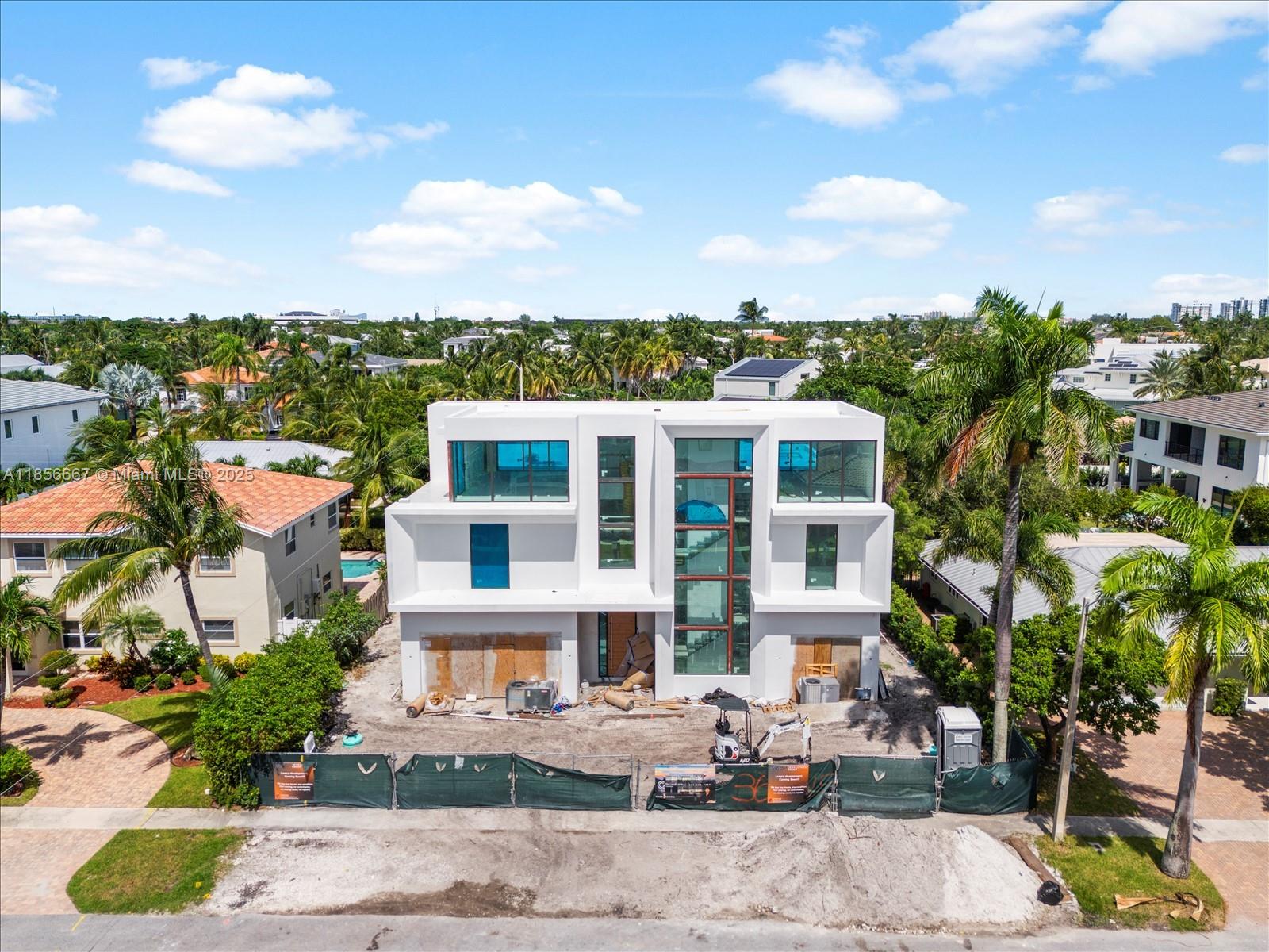 This exceptional, brand-new estate by Yacov Development Group defines modern luxury and architectural grandeur. Located in prestigious Boca Villas, this home offers resort-style living, beginning with a striking foyer with triple-height ceilings leading into an open-concept layout. Inside, five spacious bedrooms are complemented by a formal living room, dining room, office, and a gourmet chef’s kitchen with an adjacent prep kitchen for seamless culinary experiences. The third floor boasts a clubroom with a full bar and expansive open terrace, ideal for entertaining. An elevator provides access to all levels. The outdoor oasis includes a pool, covered patio, and gazebo with an outdoor summer kitchen. Located in exclusive East Boca Raton. November 2025 Completion.