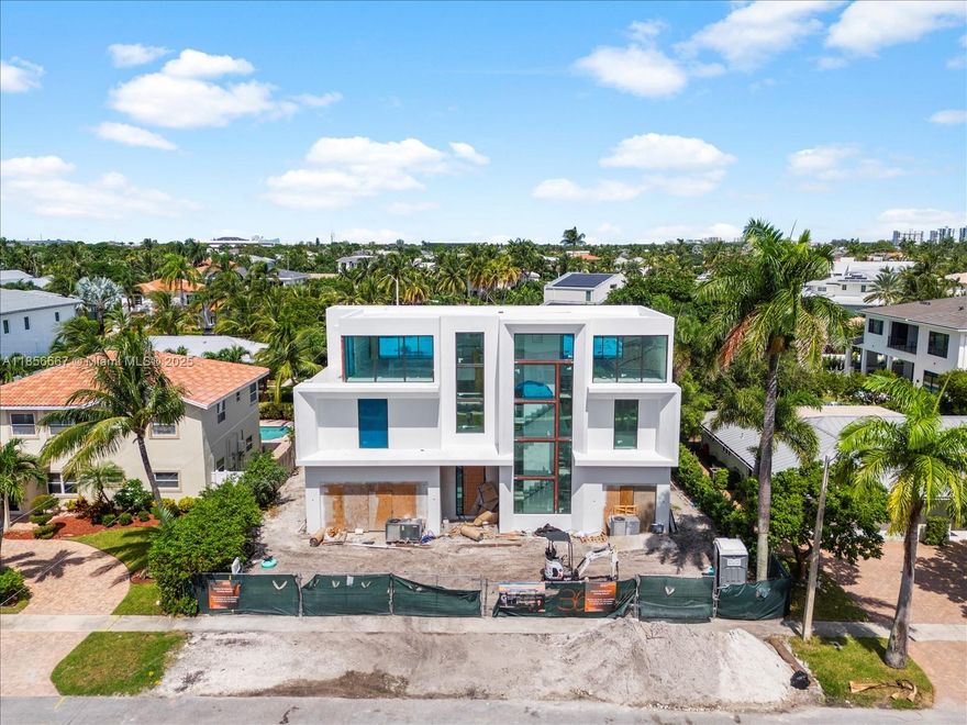 This exceptional, brand-new estate by Yacov Development Group defines modern luxury and architectural grandeur. Located in prestigious Boca Villas, this home offers resort-style living, beginning with a striking foyer with triple-height ceilings leading into an open-concept layout. Inside, five spacious bedrooms are complemented by a formal living room, dining room, office, and a gourmet chef’s kitchen with an adjacent prep kitchen for seamless culinary experiences. The third floor boasts a clubroom with a full bar and expansive open terrace, ideal for entertaining. An elevator provides access to all levels. The outdoor oasis includes a pool, covered patio, and gazebo with an outdoor summer kitchen. Located in exclusive East Boca Raton. November 2025 Completion.